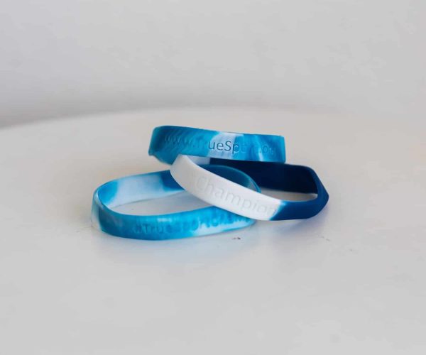 Three blue and white tie-dye TrueSport bracelets.