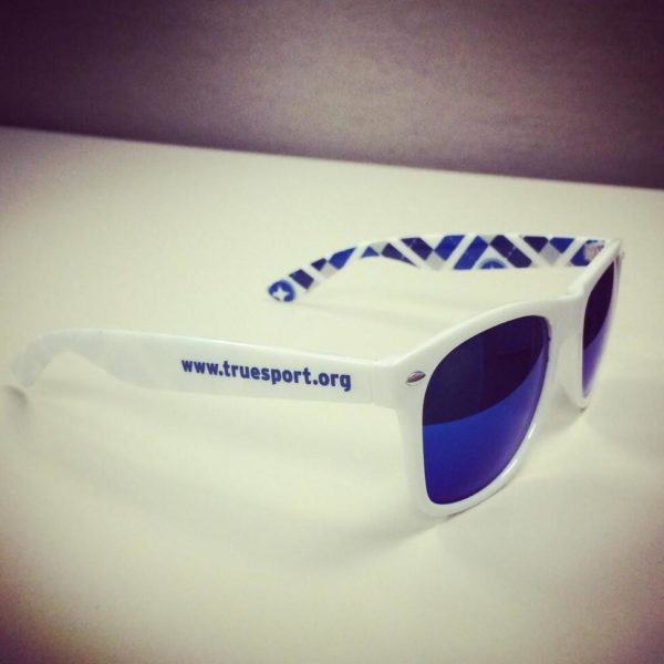 TrueSport branded white sunglasses with blue lenses.